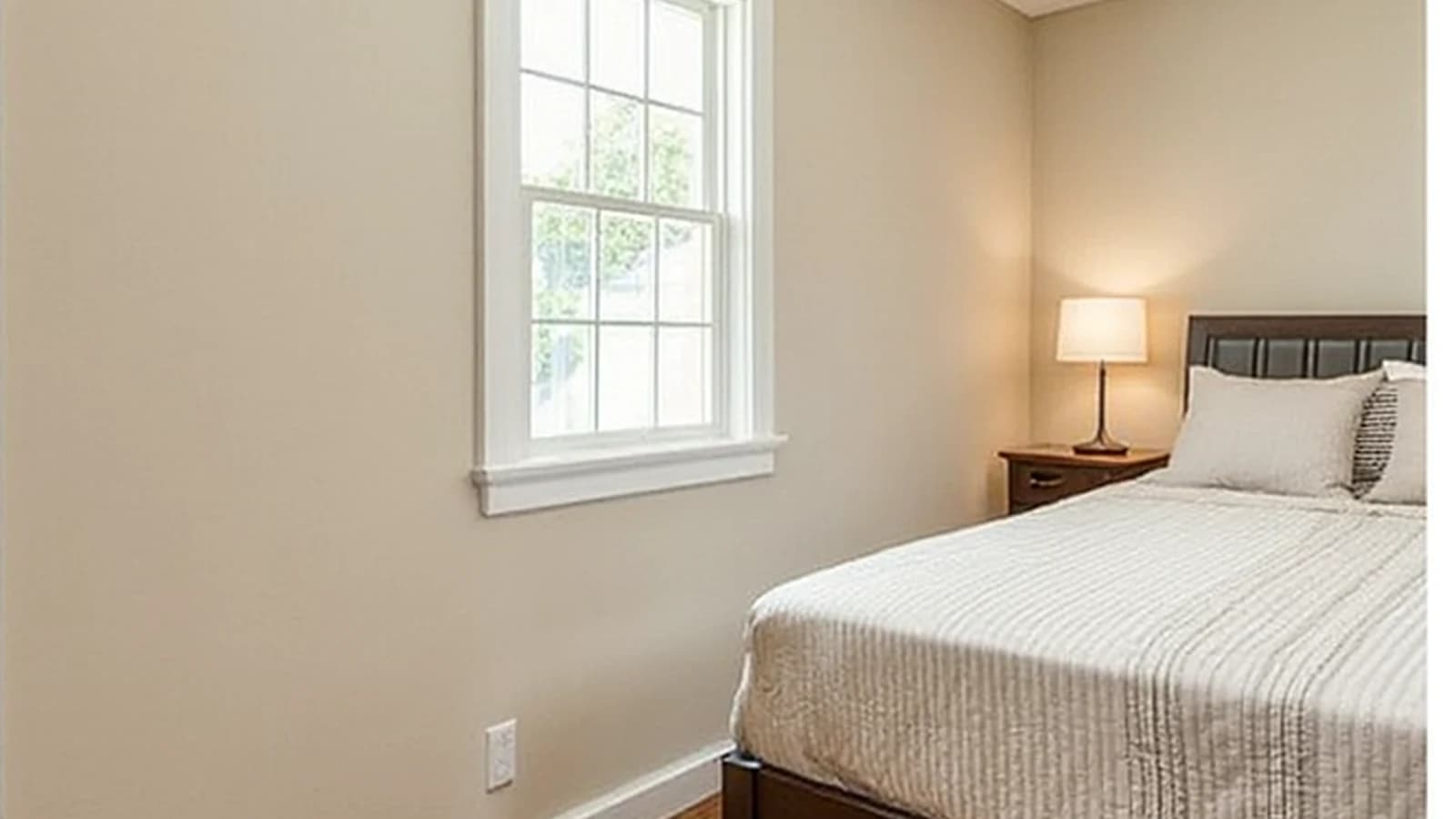 Fictional neutral bedroom with a divided-light window